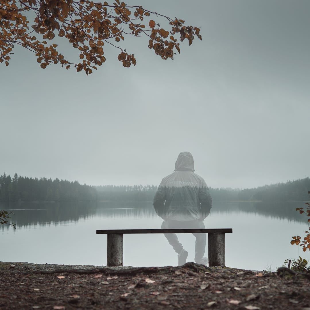 invisible individual looking at a lake