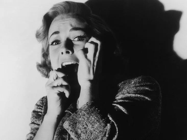 Actress Vera Miles screaming in terror in a still from the movie Psycho.