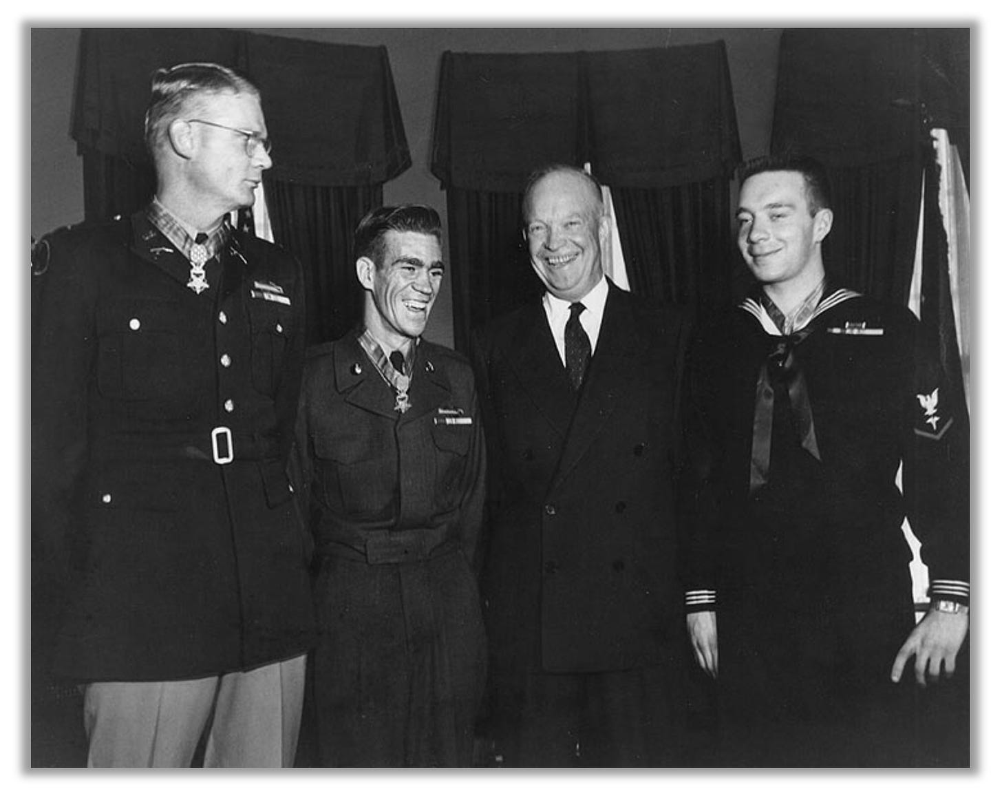 Eisenhower poses with three Medal recipients, including Ernie West.