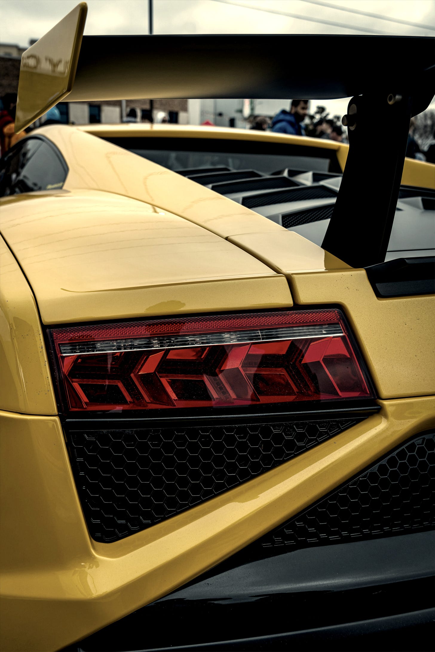 A yellow sports car parked in a parking lot