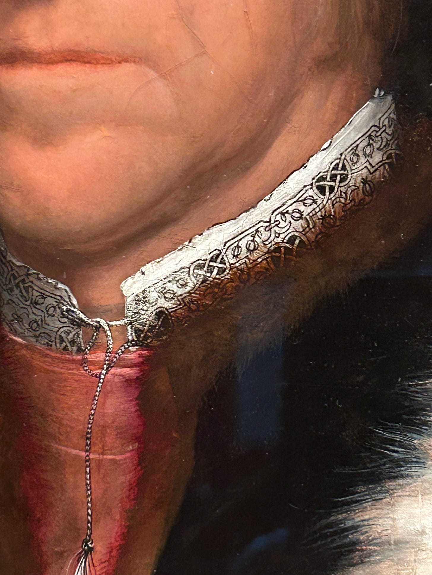 A close up of the portrait of the Duke of Norfolk highlighting his mouth and chin, his white collar embroidered with blackwork, and the brown fur collar of his coat