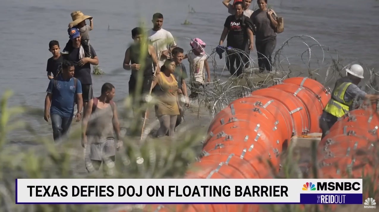MSNBC screenshot of migrants wading in Rio Grande next to coils of concertina wire and orange buoys while Texas workers install more