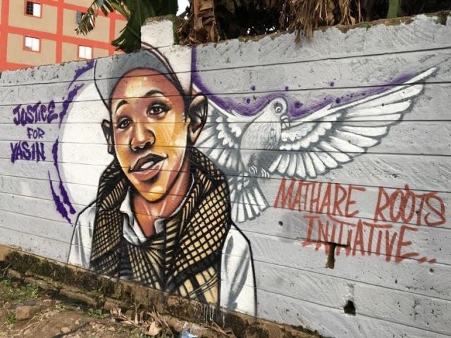 A mural shows a young boy in a tweed vest and a hat, with a dove over his shoulder, and the text "justice for Yasin"