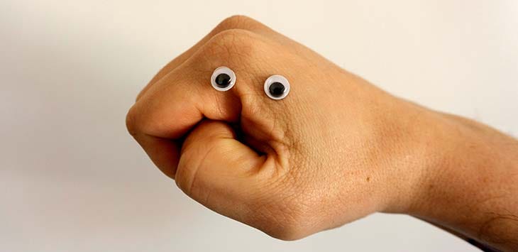 Photo of a hand with googly eyes stuck on it.