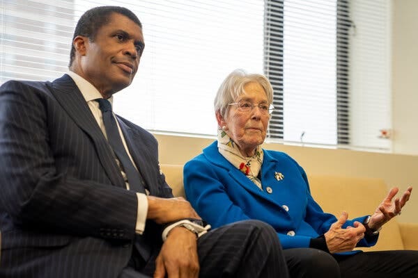 Dr. Philip Ozuah, in a dark suit and tie, and Dr. Ruth Gottesman, in a blue jacket, sit side by side.