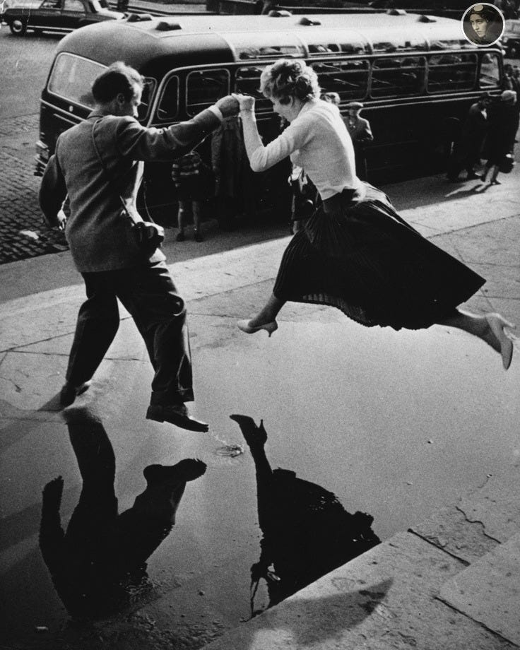 May be a black-and-white image of 2 people, people dancing and street