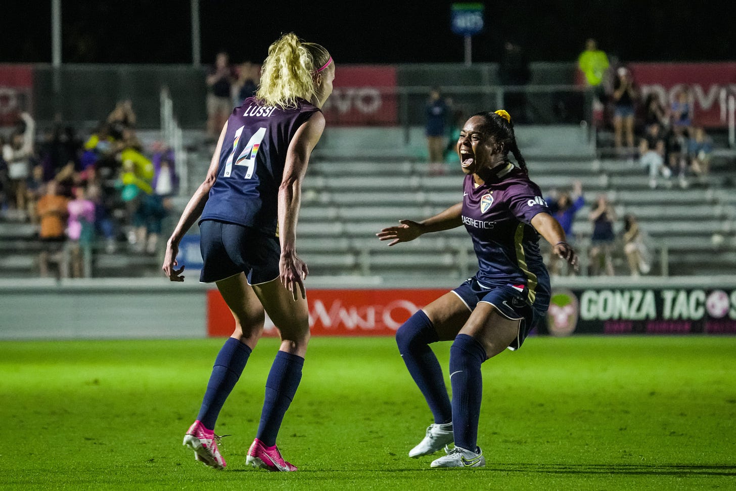 North Carolina Courage players Tyler Lussi and Kiki Pickett celebrate Lussi's goal against the Houston Dash.