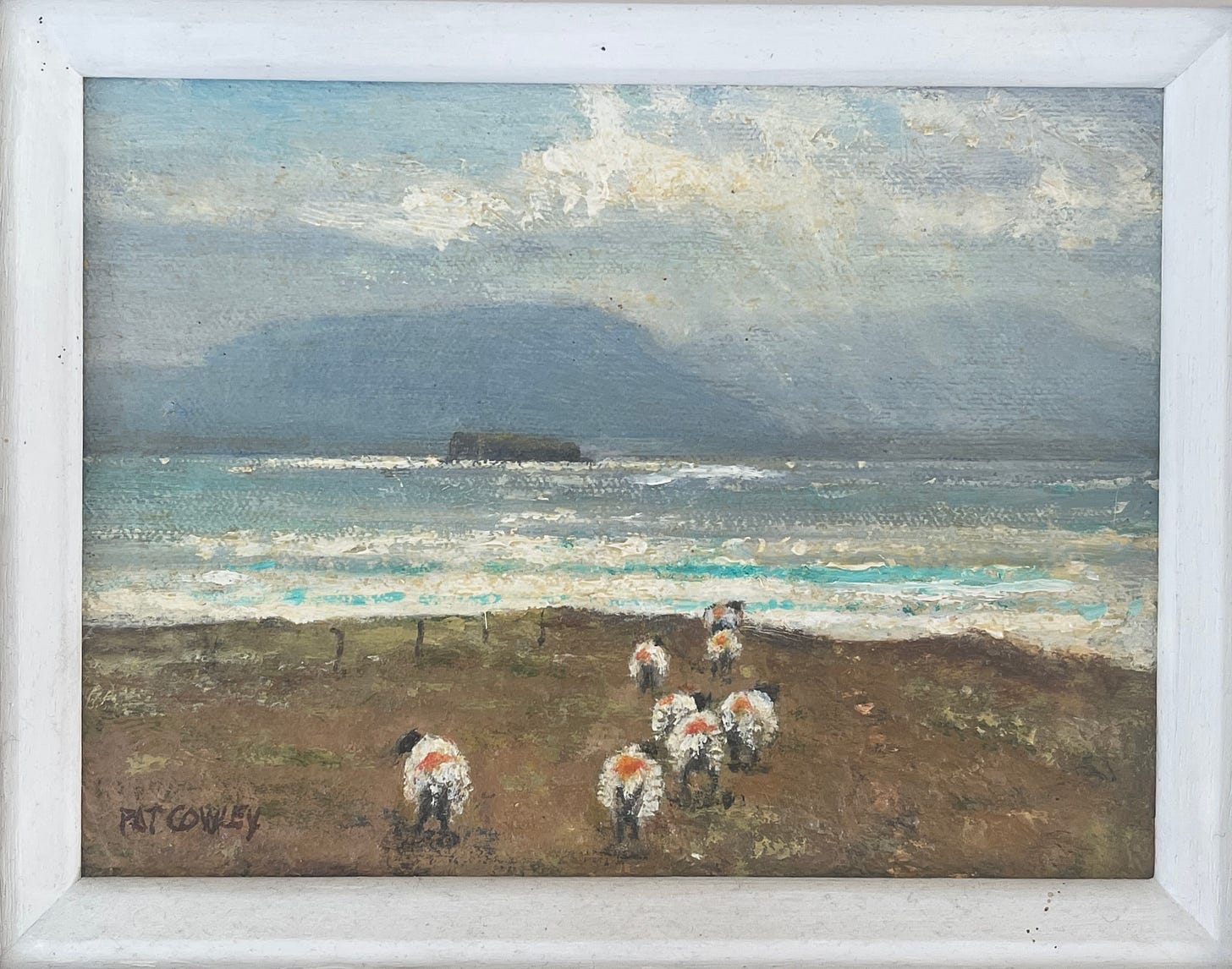 A picture of sheep by the sea by Pat Cowley