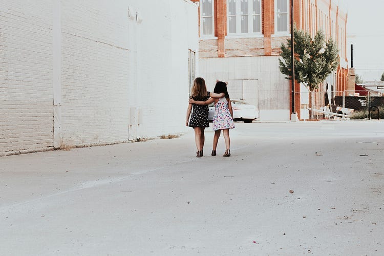 Two young friends walking together.