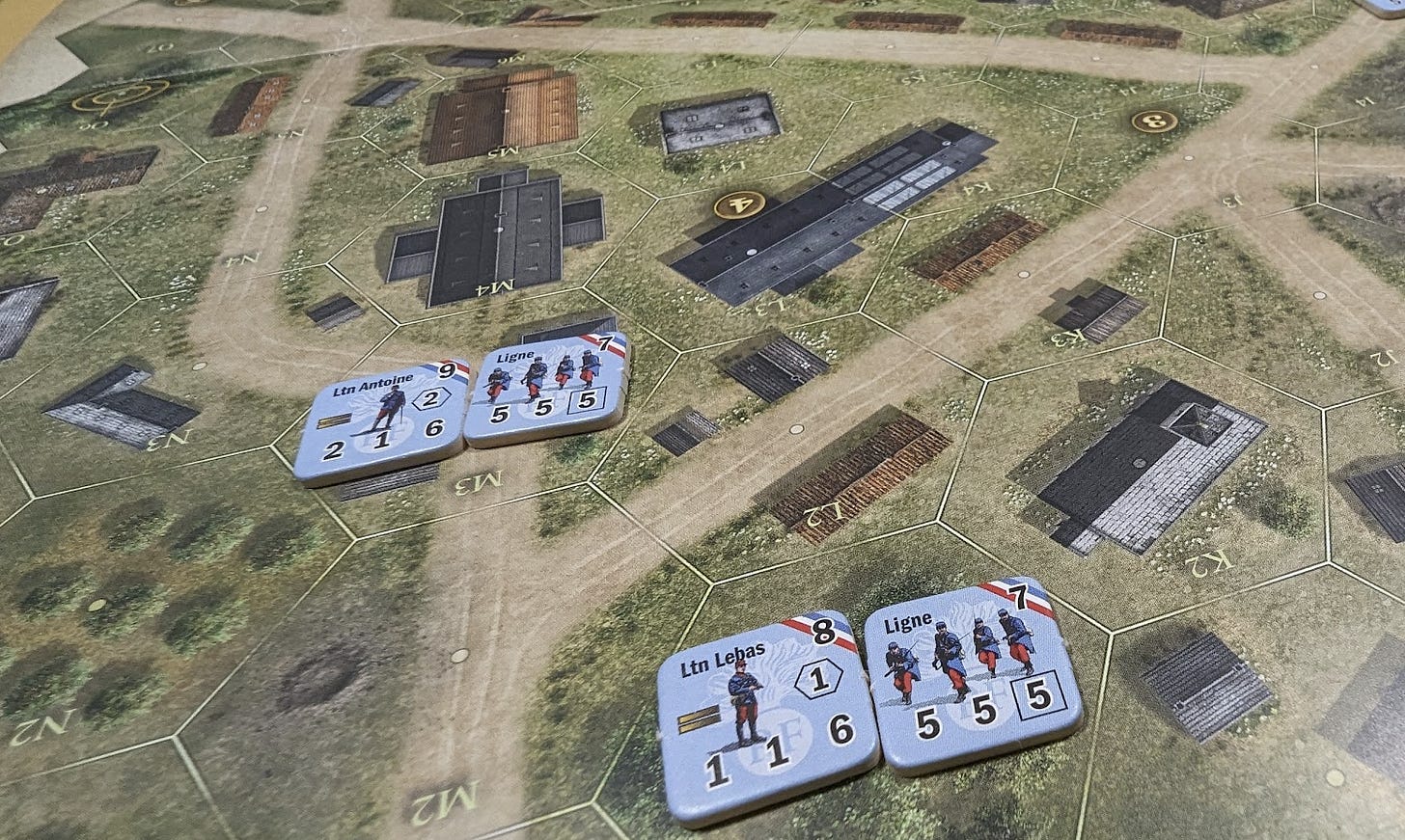 A board of the game Great War Commander, depicting a French village in WW1. There are four French troop counters on the map.