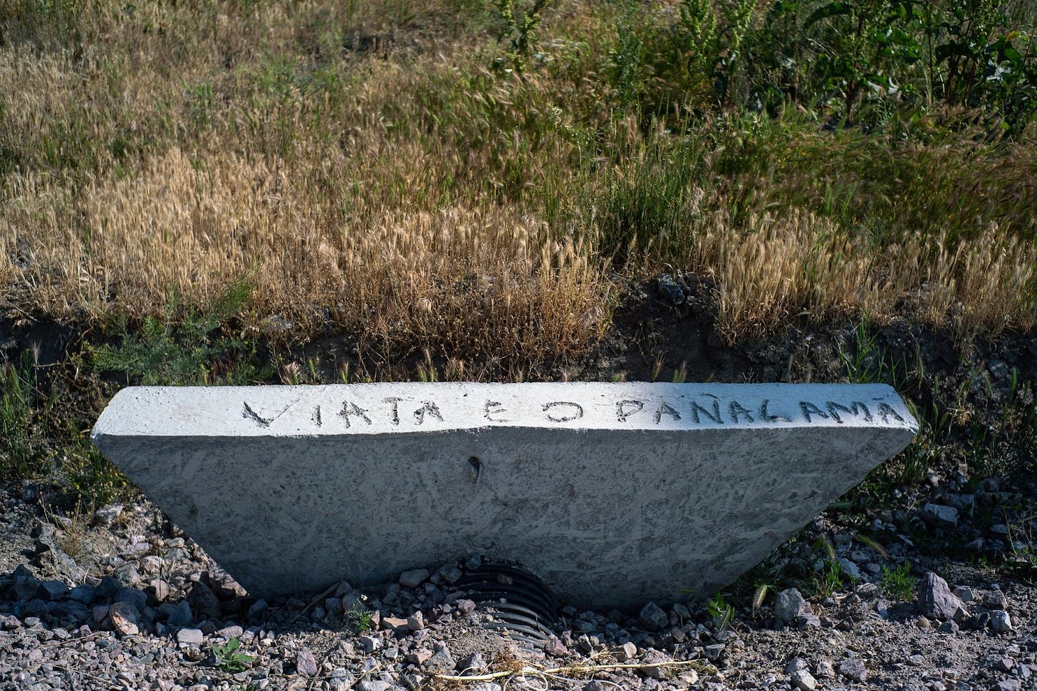 A concrete drain with writing on it

Description automatically generated