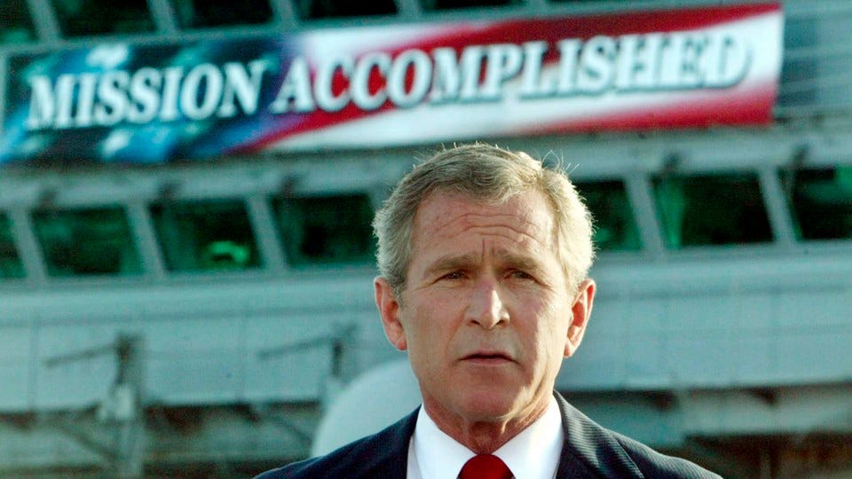 George Bush in front of the famous Gulf War “Mission Accomplished” banner. 
