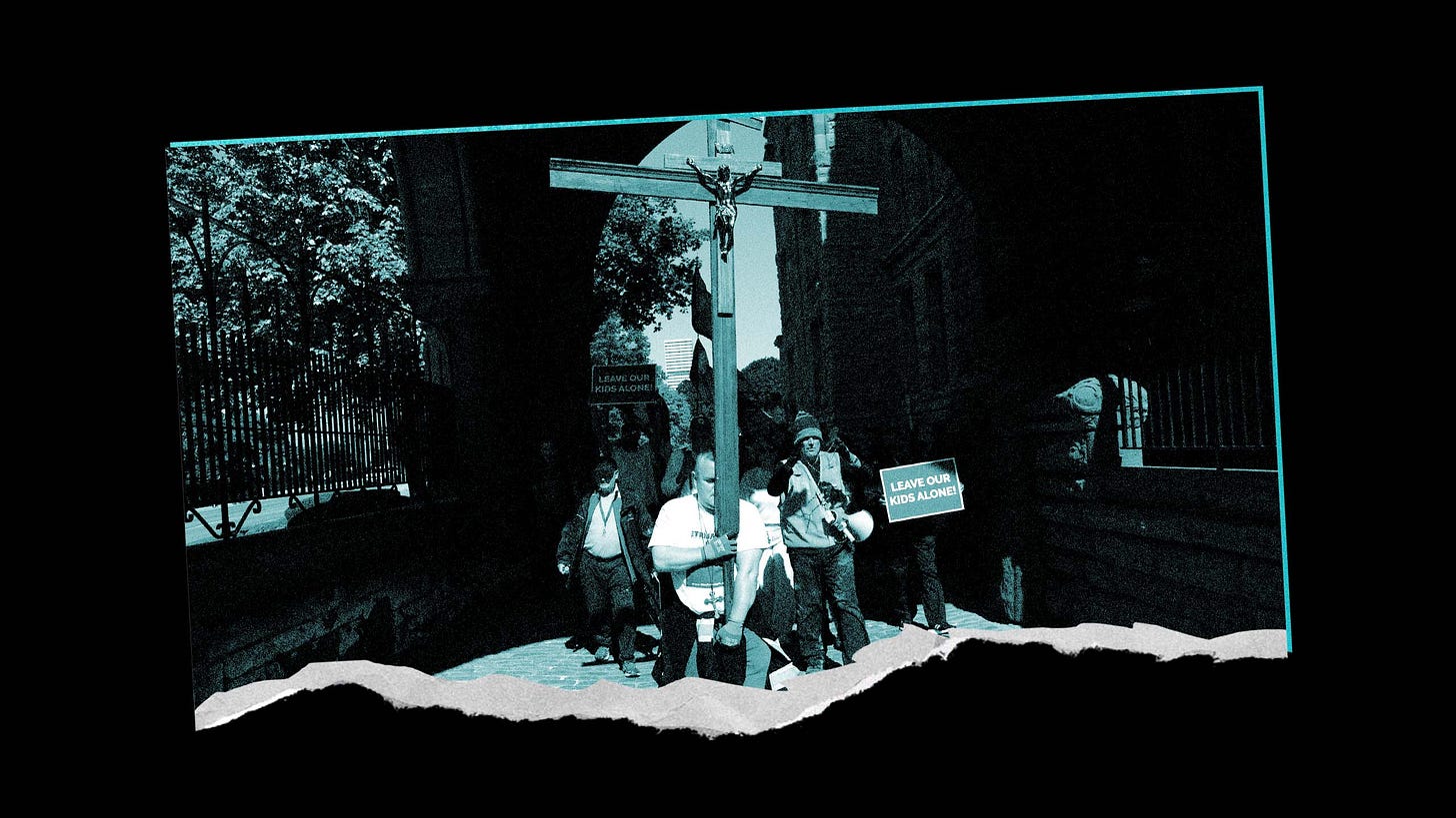 An image made to look like a torn photo depicting a small group of protestors holding signs that read, “Leave Our Kids Alone.” The person in the front holds a very large wooden cross. The image in edited to be black and teal.