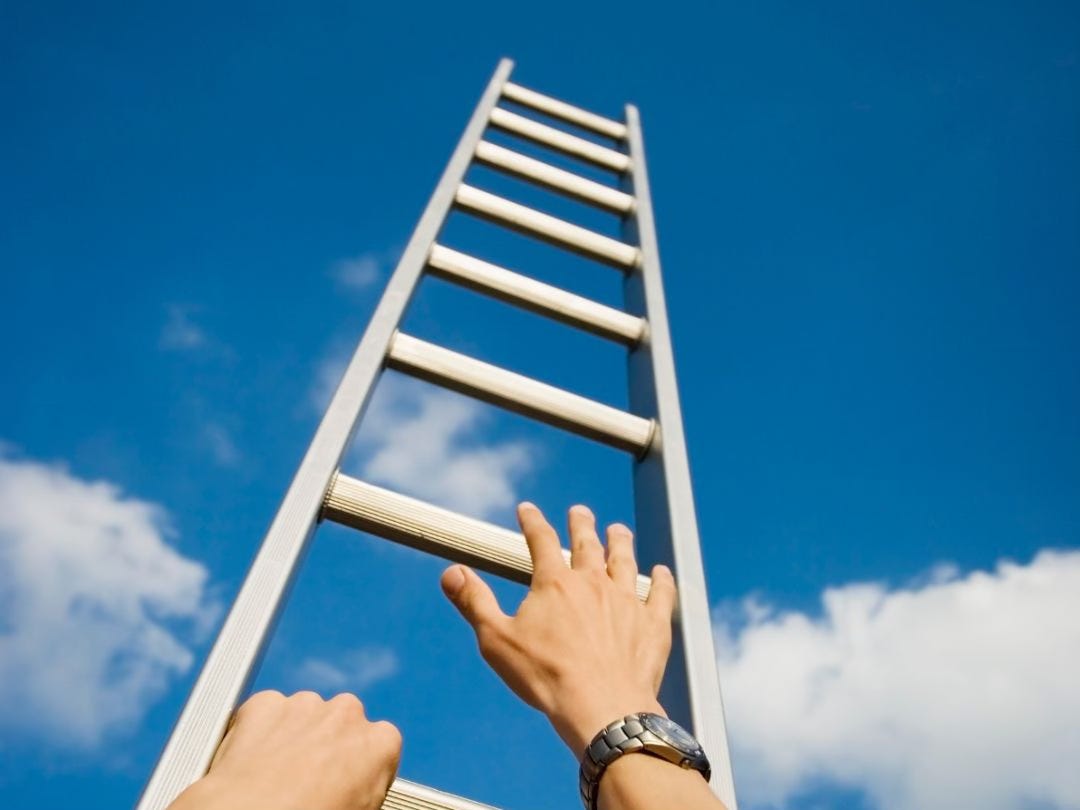 Photo of a person climbing a very tall ladder into the sky.