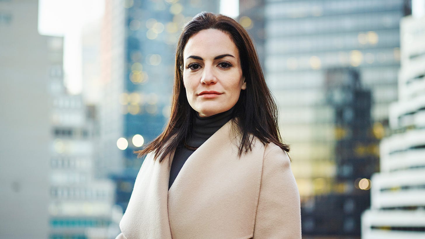 A photo of The Trace senior news writer Jennifer Mascia in the foreground with skyscrapers in the background