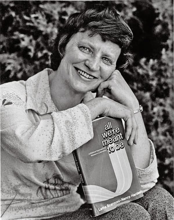 A black and white photo of a smiling Ms. Scanzoni in a casual sitting pose — her arm propped against her knee, her folded hand against her jaw — as she holds a book in her lap.