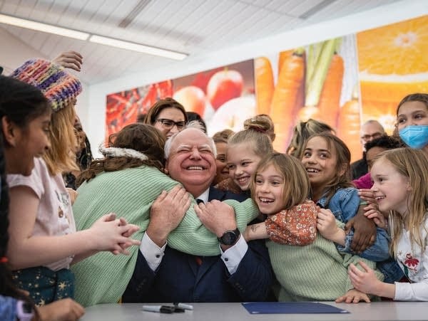 School children embrace a politician