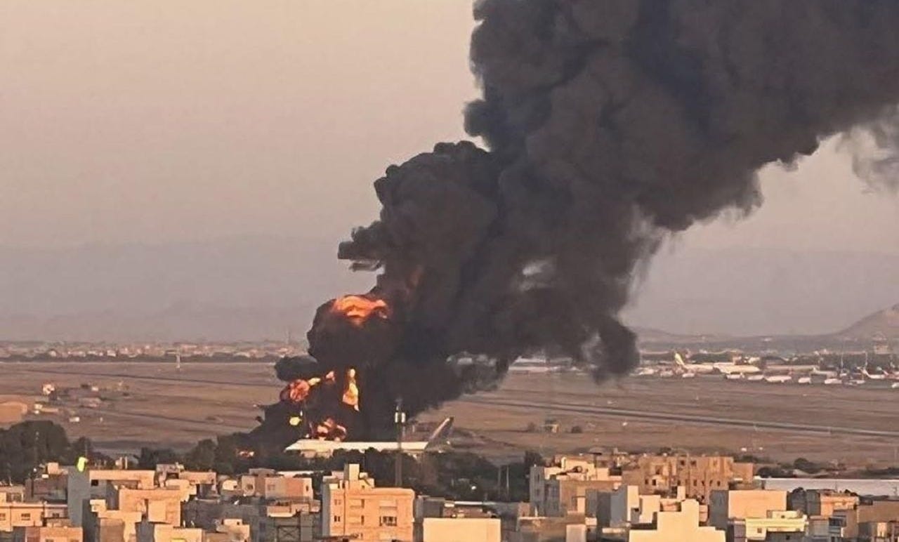 A photo taken Sunday shows a large fire at Mashhad Airport in eastern Iran. A photo taken Sunday shows a large fire at Mashhad Airport in eastern Iran.