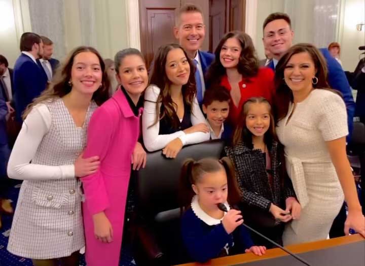 Family pictured in congressional hearing room.