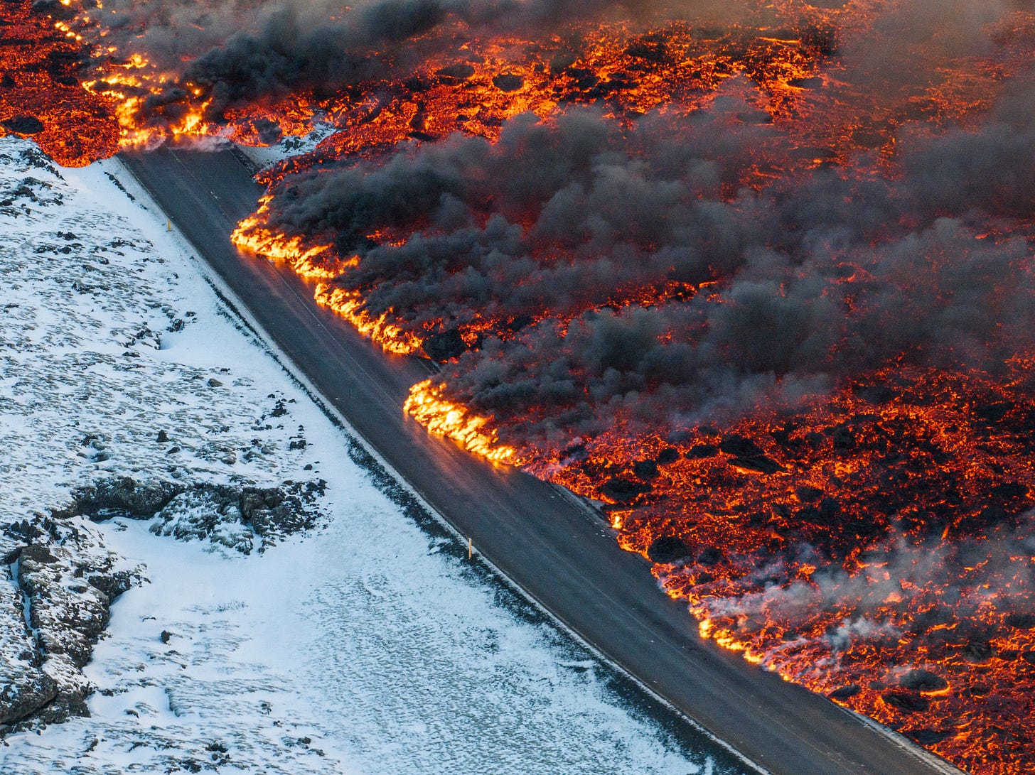Photo of lava flowing onto the road leading to the Blue Lagoon in Iceland.