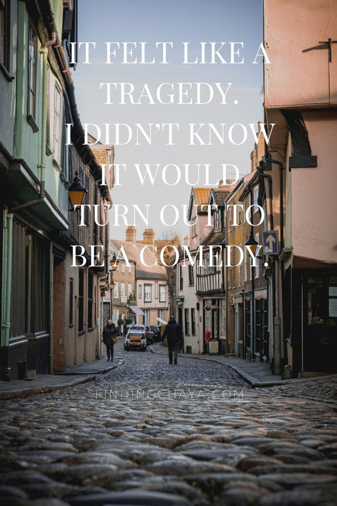 White text laid over the image reads: It felt like a tragedy. I didn’t know it would turn out to be a comedy.
The image is of a cobbled street with buildings either side in an English town.
