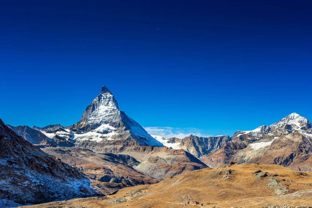 The Matterhorn mountain lit up at dawn in Zermatt, Switzerland.