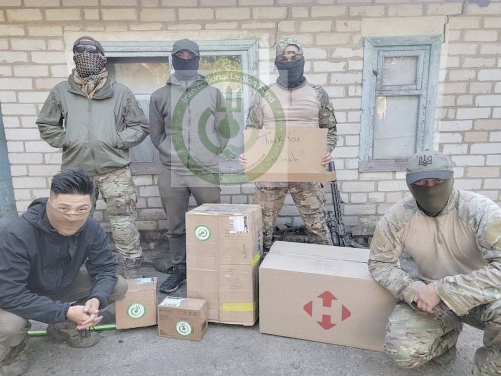 Members of Recon Team "Kilo" receiving a delivery from ILF