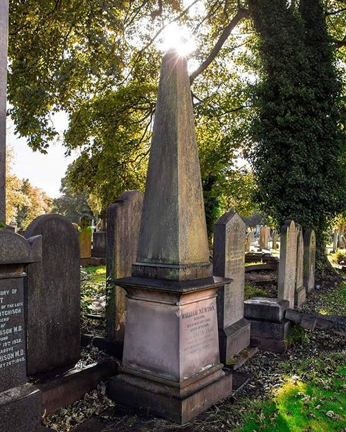 A headstone topped with an obelisk.