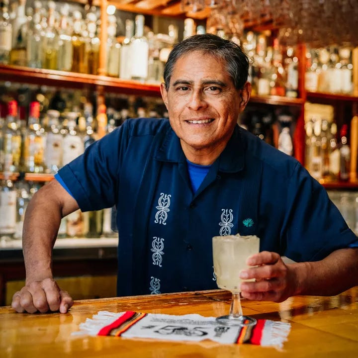 Julio Bermejo behind bar of Tommy's Mexican Restaurant with Tommy's Margarita