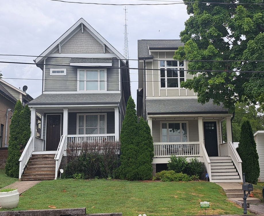 Two skinny houses sitting side-by-side.