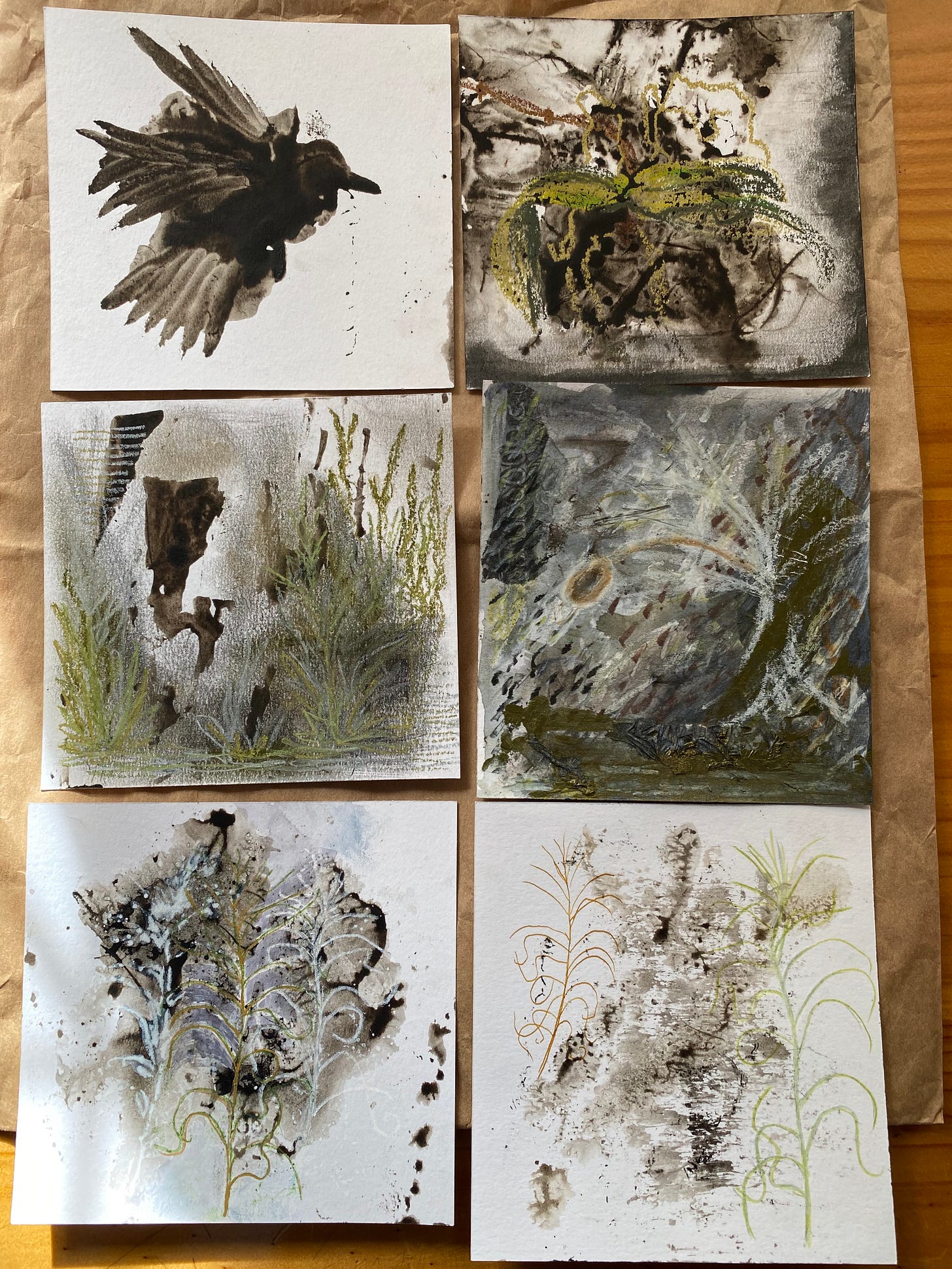 six sheets of paper decorated with pomegranate ink and mixed media in shades of gold and green and black