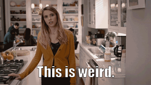 A woman throws her hands up and says this is weird.