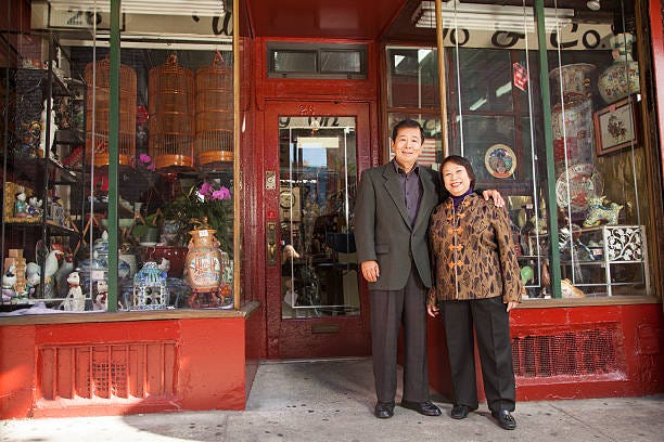 Asian family in front of store Asian family in front of store immigrant business stock pictures, royalty-free photos & images