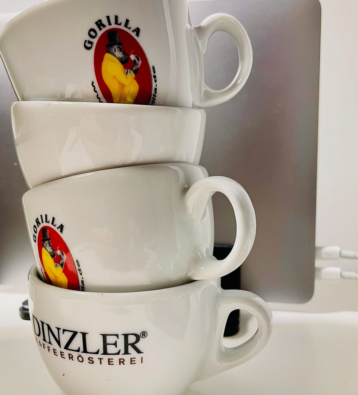 A pile of espresso cups on a desk