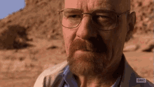 A meme animated GIF featuring Walter White from Breaking Bad saying, "Coward!"