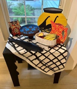A table with a tablecloth and a tablecloth with a tablecloth and a tablecloth with a tablecloth and a tablecloth with a tablecloth and a bowl of fruit on it

Description automatically generated