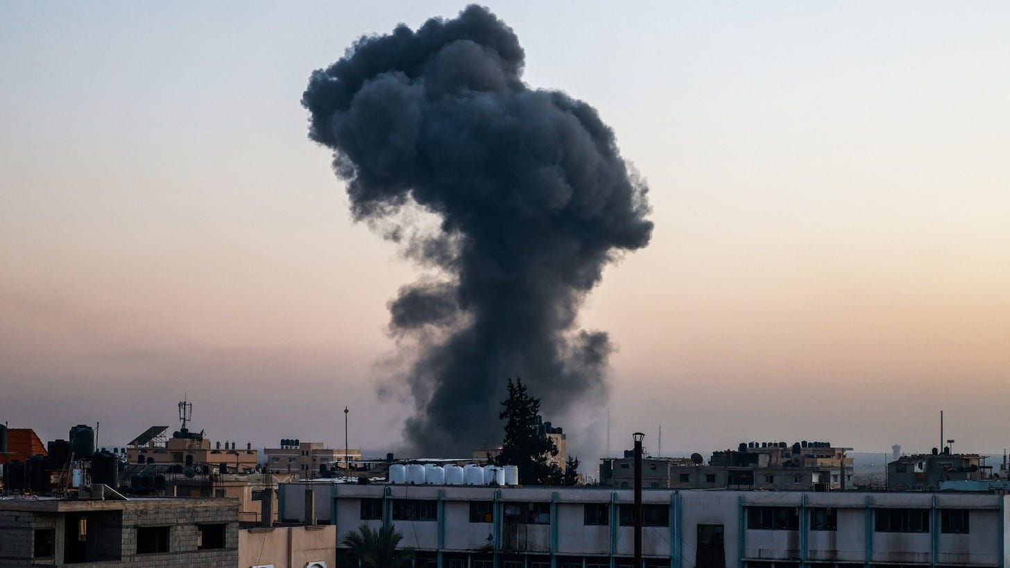 A billow of smoke rises over buildings after an Israeli strike in Rafah, southern Gaza Strip, on 4 April 2024.