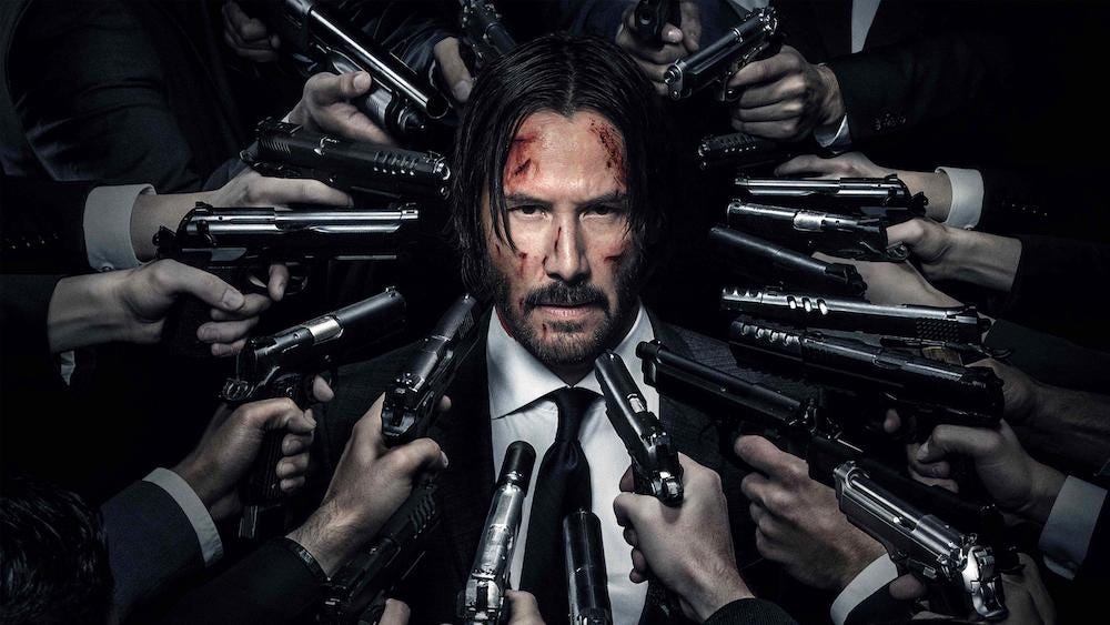 John Wick surrounded by guns