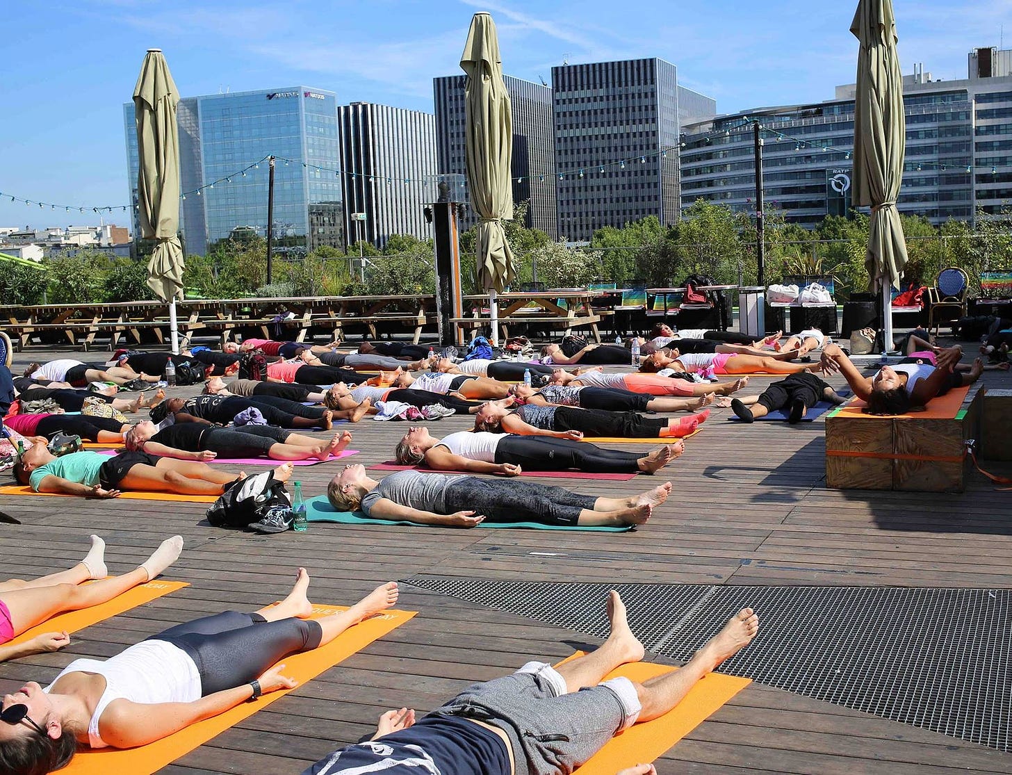Outdoor yoga class relaxation in Paris, France