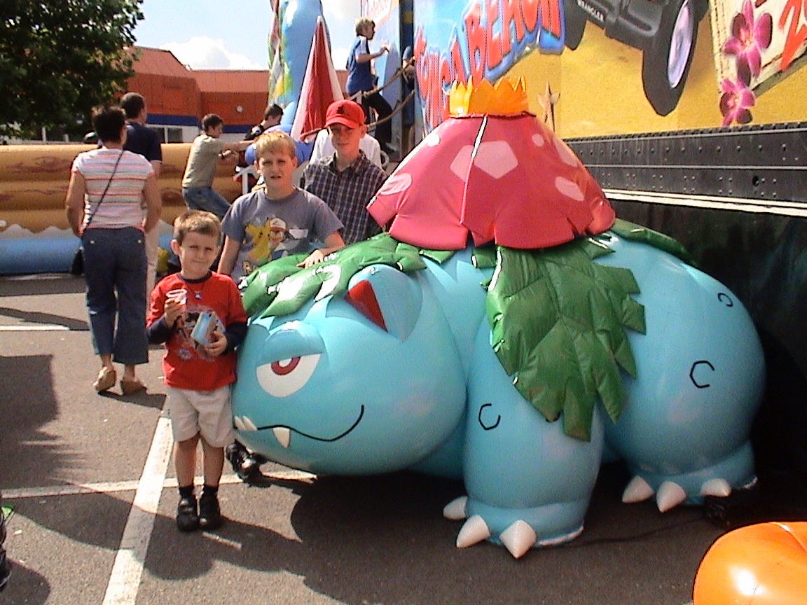 A photograph of Luke, his best friend, and his brother at the Nintendo Konga Beach Road Trip on October 1st, 2004, alongside an inflatable Venusaur