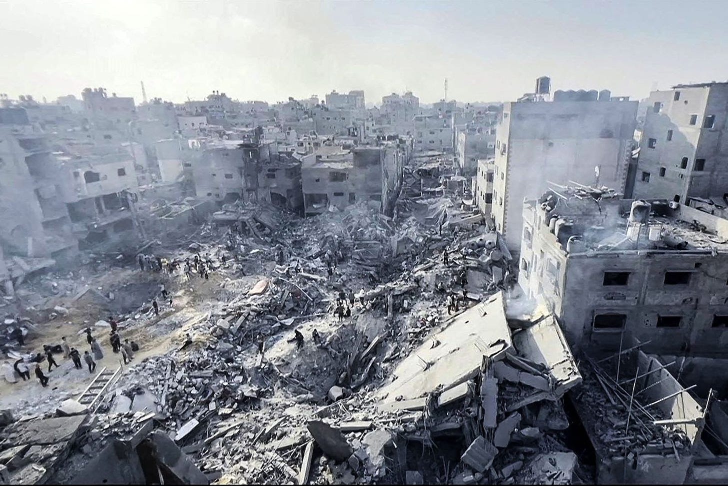 Palestinians check destruction of the Jabalia refugee camp in Gaza.