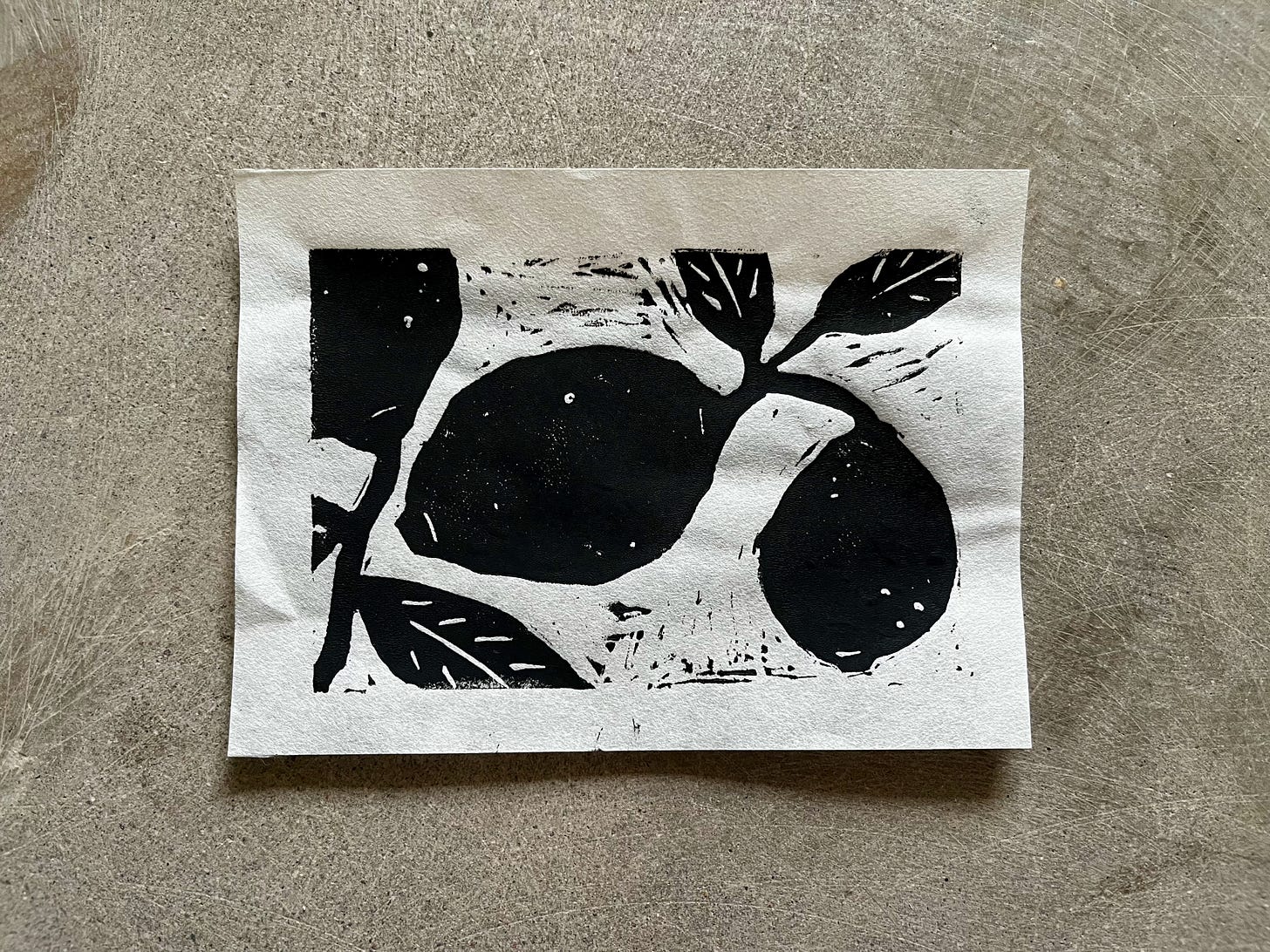 a piece of white paper with black lemons and leaves printed on it