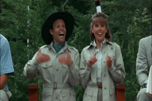 A gif from Addams Family Values of two camp counsellors dancing goofily.