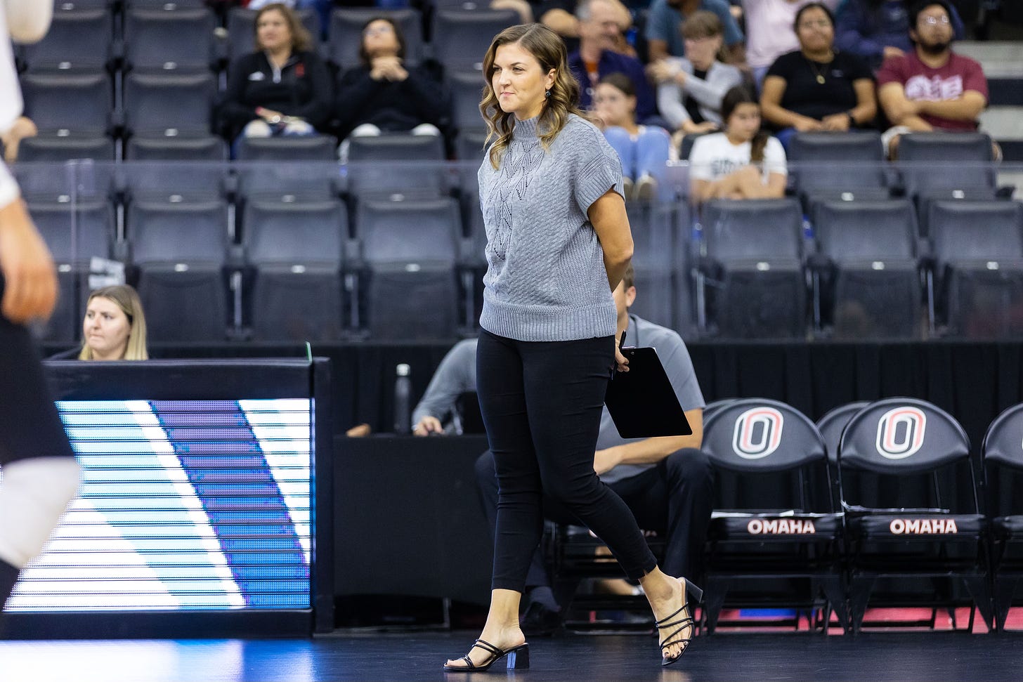 Kelly walks the sideline during a match