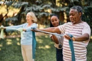 Black senior man exercising with others