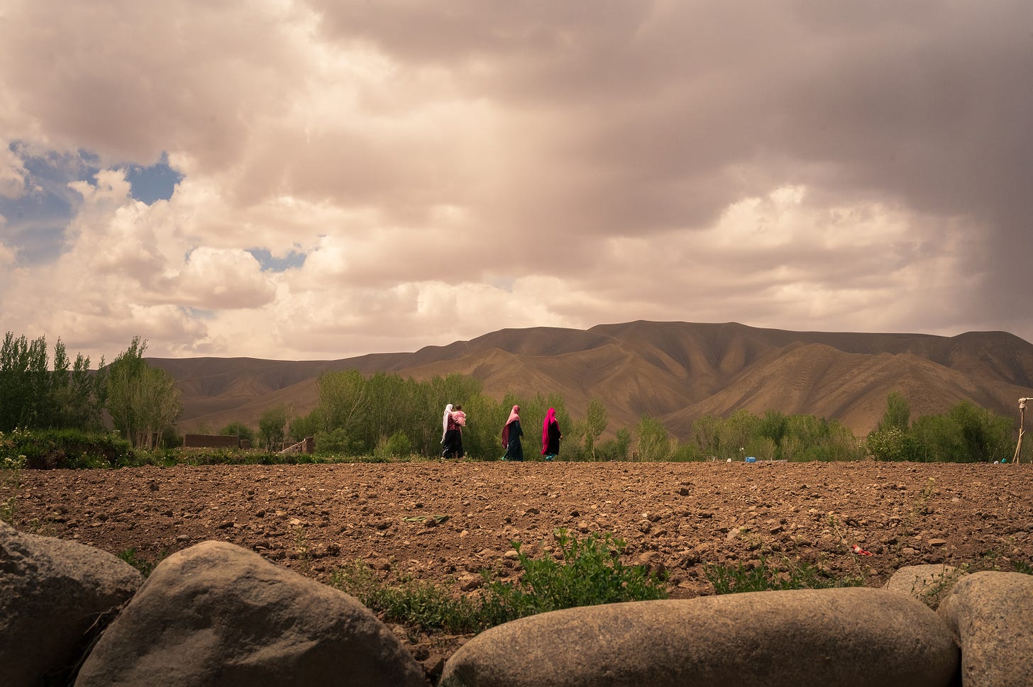 Women walk in Bamiyan province on May 22, 2023. (Photo by Elise Blanchard for The Washington Post via Getty Images).