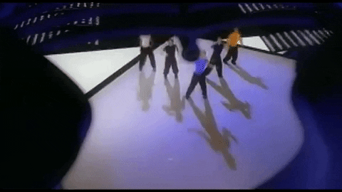 NSYNC dancing in the same outfits, this time we're watching from above them