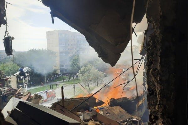 In this photo provided by the Ukrainian Interior Ministry Press Office, emergency services work at a scene after a missile hits a multi-story apartment building in Kryvyi Rih, Ukraine, Monday, July 31, 2023. (Ukrainian Interior Ministry Press Office via AP)