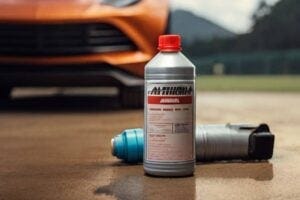 a bottle of ammonia sitting on the ground in front of a sports car