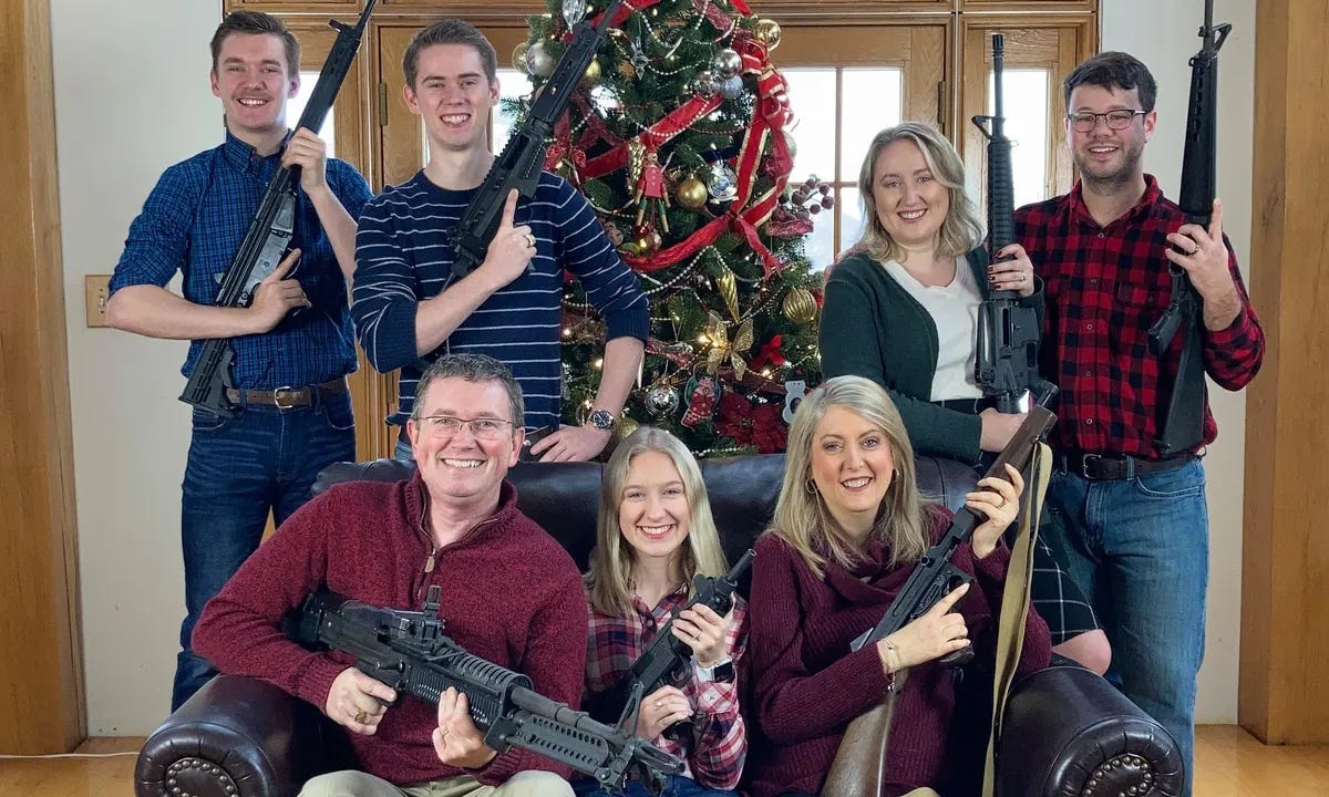 Representative Thomas Massie and his family pose for a Christmas photo. All of them are wearing huge smiles and all of them are holding massacre weapons designed to murder as many people as possible as quickly as possible.